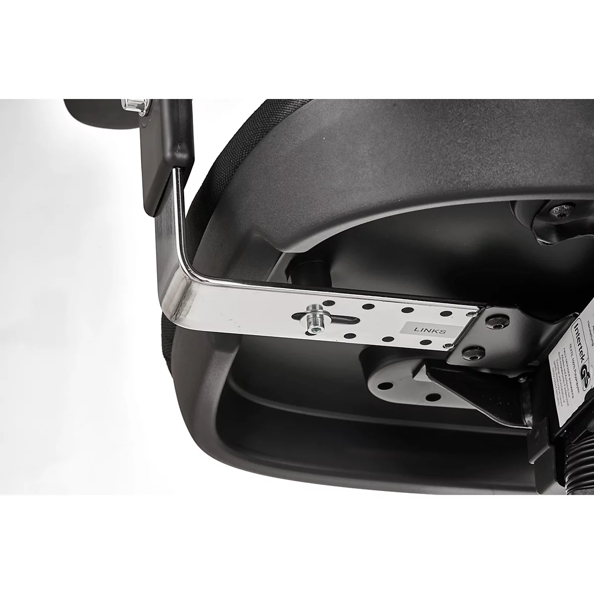 Close-up of a black office chair. A silver metal brace connects the backrest to the seat. The detail shows screws and brackets.