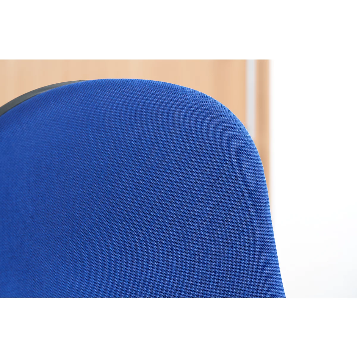 Close-up of a blue chair back with fabric cover.