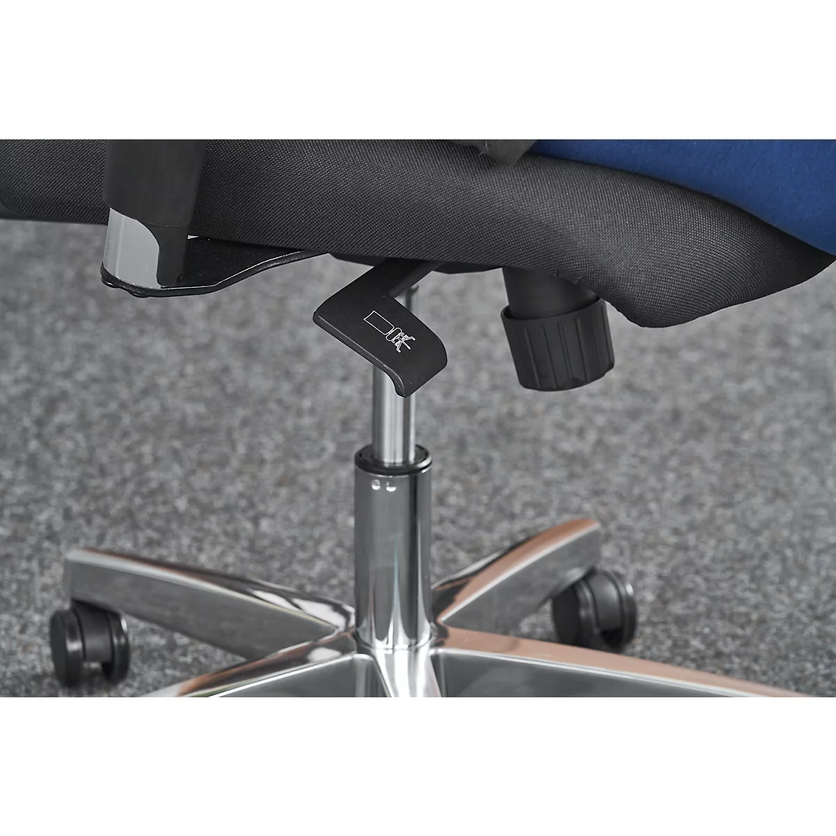 Detailed shot of a chair mechanism, lever with pictogram.