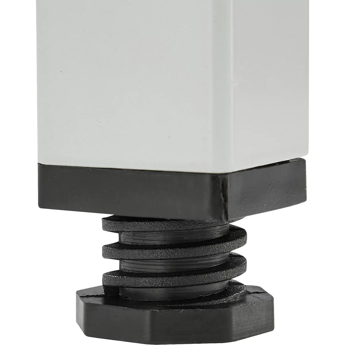 Nahaufnahme eines Möbelbeins mit einer schwarzen Basis und einer Federung.