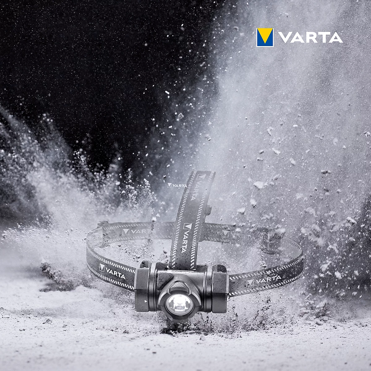Varta headlamp surrounded by a white dust explosion. Details of the lamp can be seen.