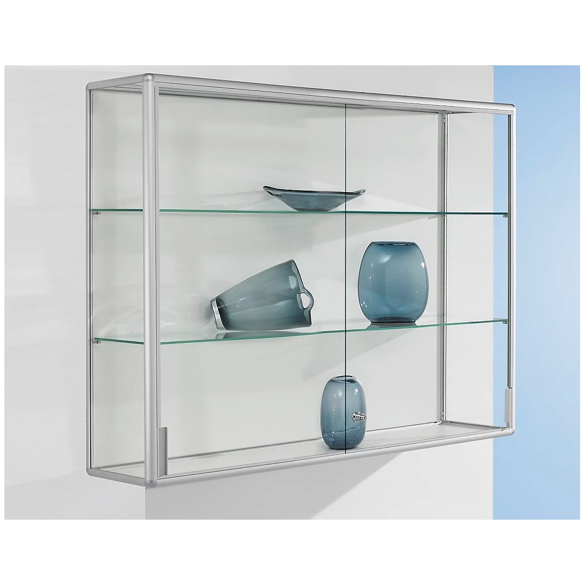 Glass cabinet with silver frame, filled with blue vases and bowls.