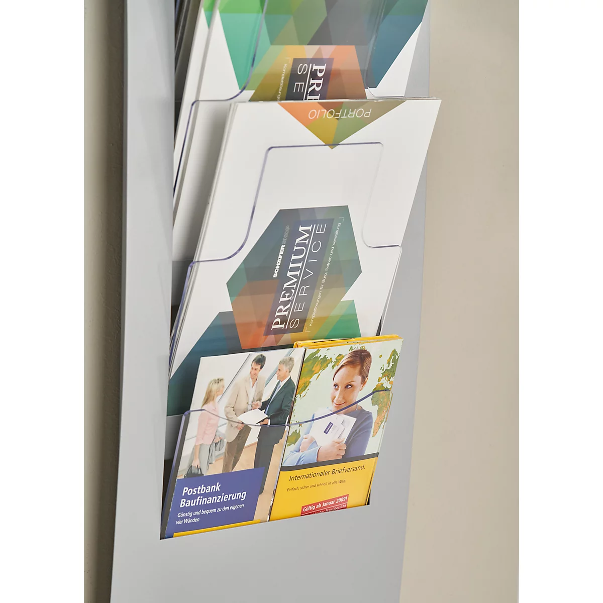 Gray brochure holder with various brochures: Premium Service, Portfolio and construction financing.