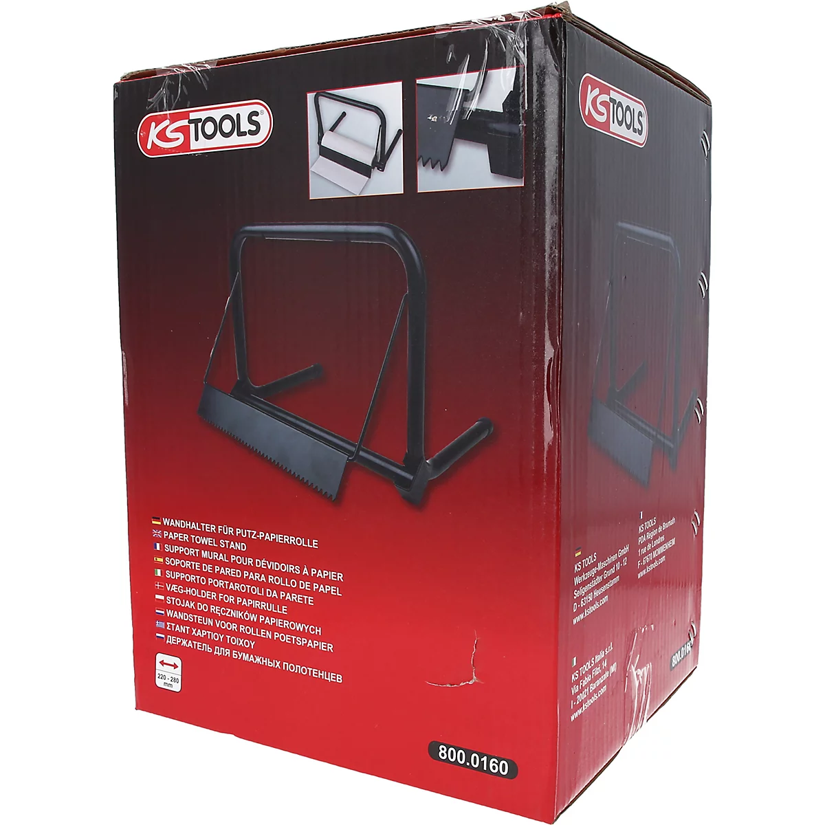 Schwarzer Papierhandtuchhalter auf roter Verpackung. Auf der Verpackung Logos und Produktbeschreibungen.