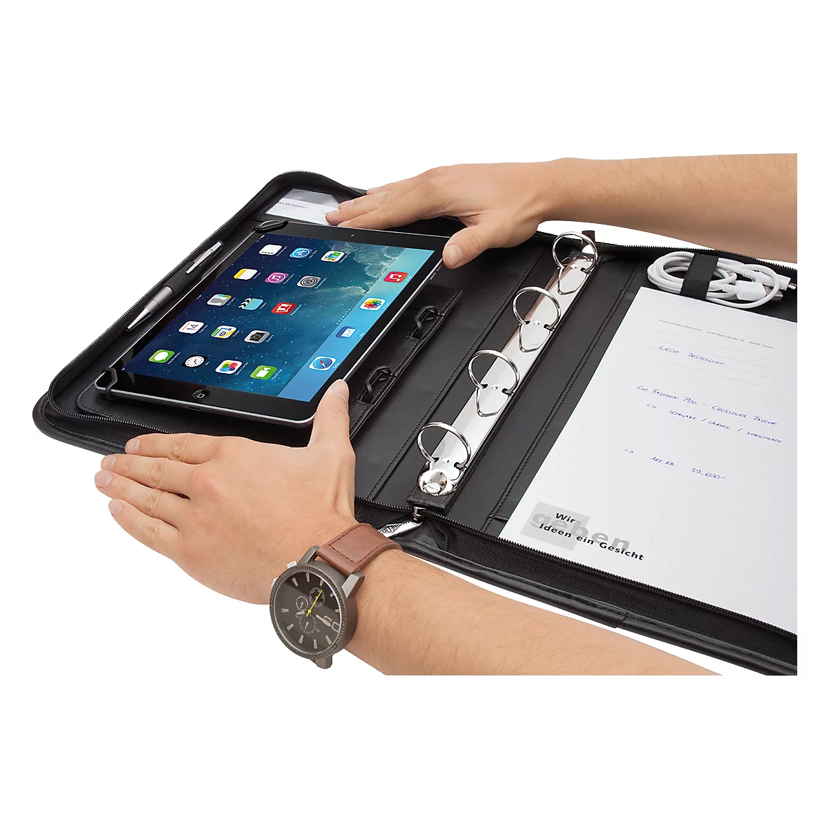 Person holding a black document case with an iPad. The case also has notepaper, a binder, and a charging cable.