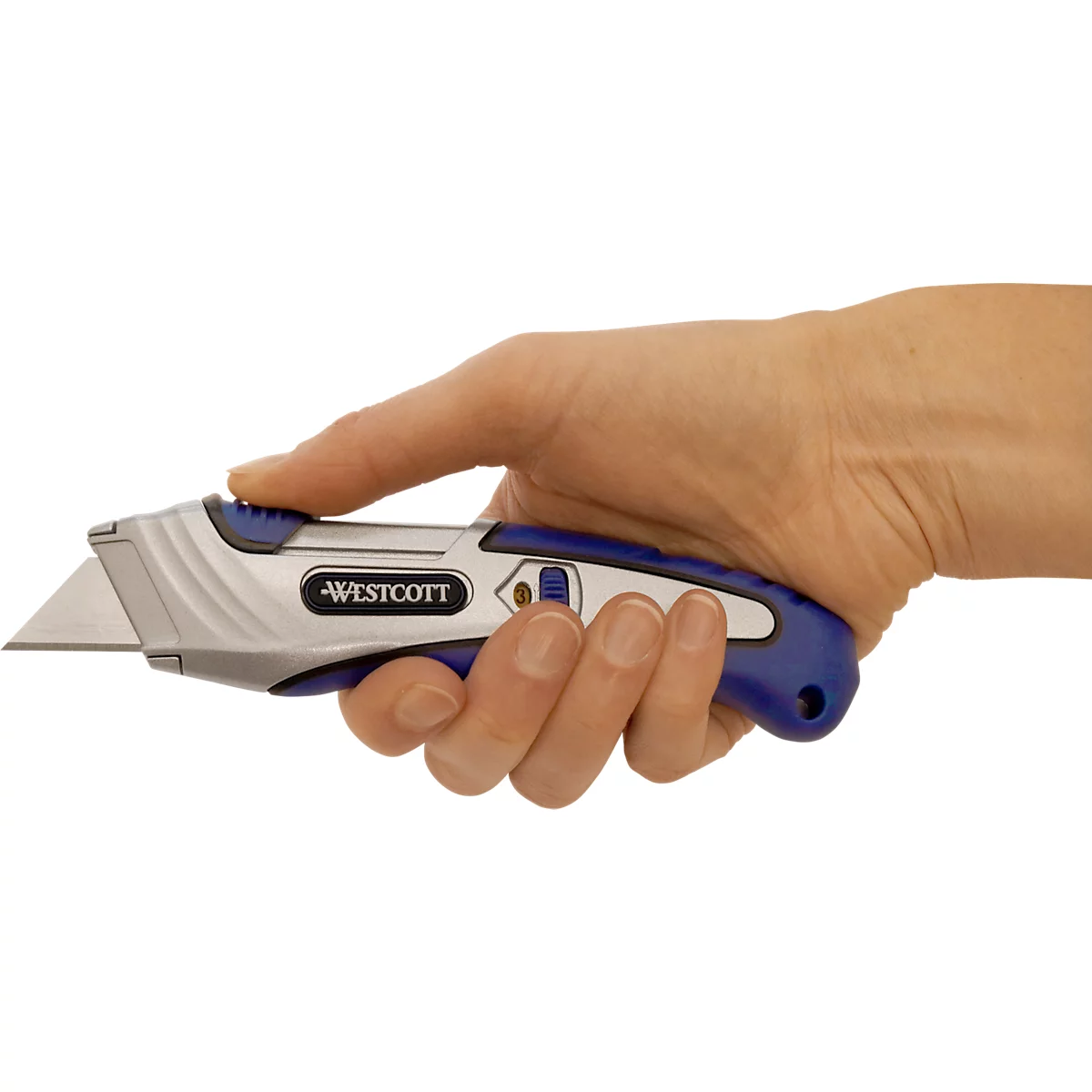 Close-up of a hand holding a Westcott utility knife. The knife has silver and blue elements and an exposed blade.