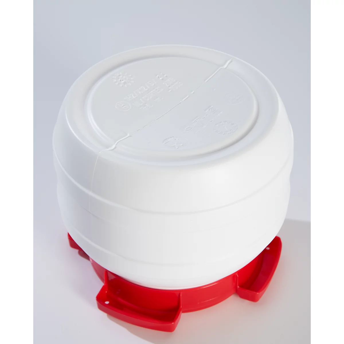 White, round container with a red foot on a white background. The container has a round shape and is inscribed at the top.