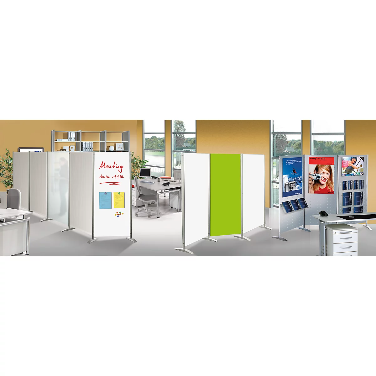 Office with partition walls. A white board with notes, two yellow and blue notes, and a green element.