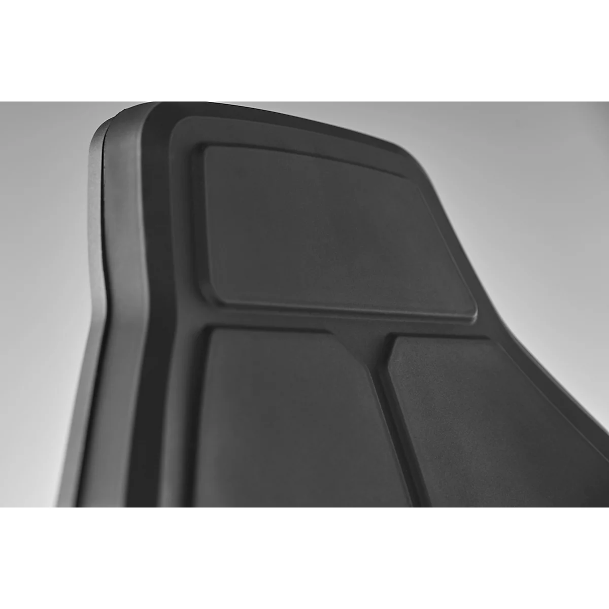 Close-up of a black backrest with rectangular and curved shapes.