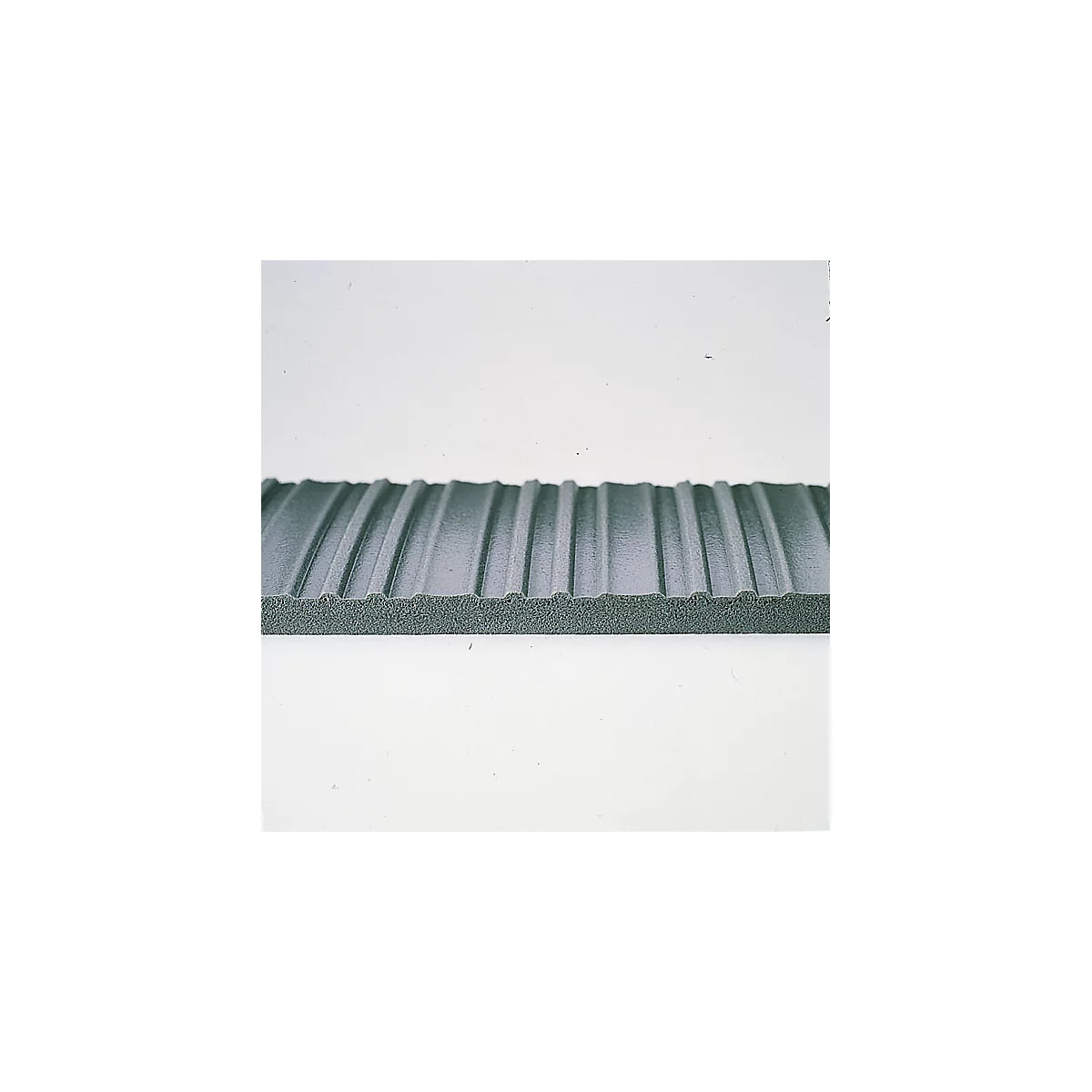 Close-up of a gray, ribbed foam board. The ribs run parallel.