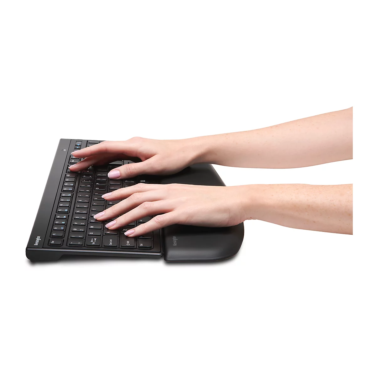 Hands typing on an ergonomic keyboard. Dark keys, wrist rest. 